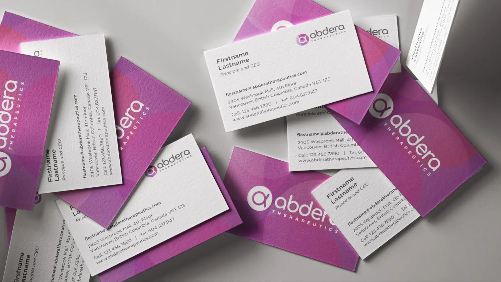 Abdera Therapeutics business card design with pink and purple branding