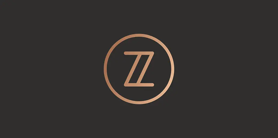 Zero Zero circular Z icon in copper on dark background