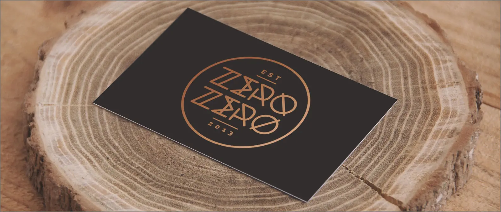Zero Zero printed business card with logo on wood background